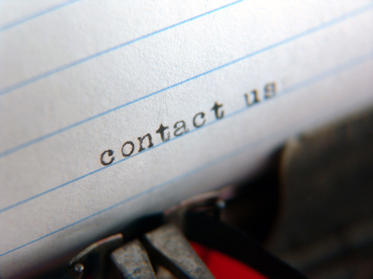 Free Contact Us Typed on Paper Stock Photography