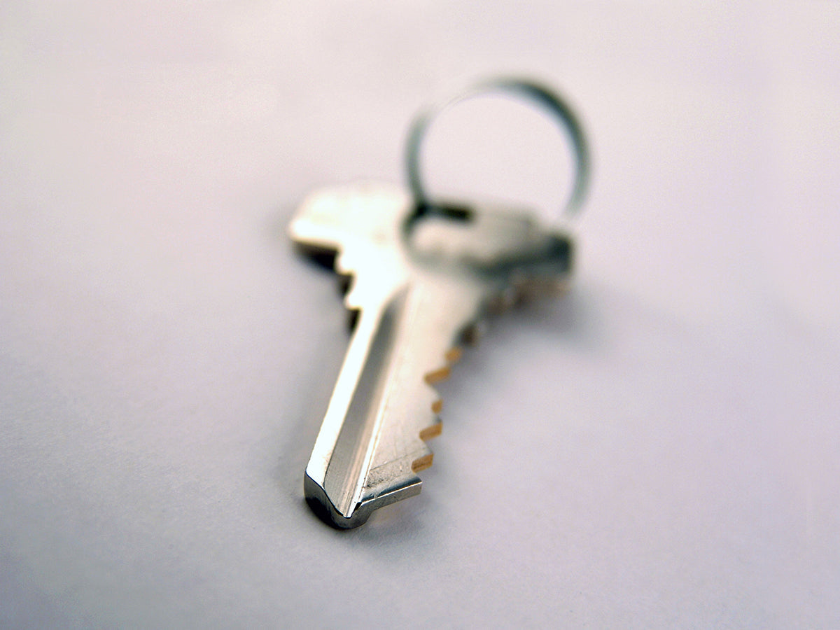 Free Key with Ring on White Surface Stock Photography