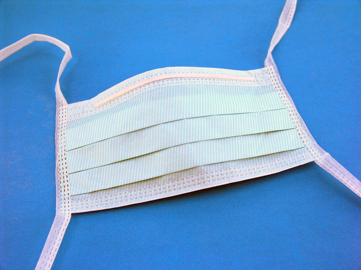 Free Medical Face Mask on Blue Background Stock Photography