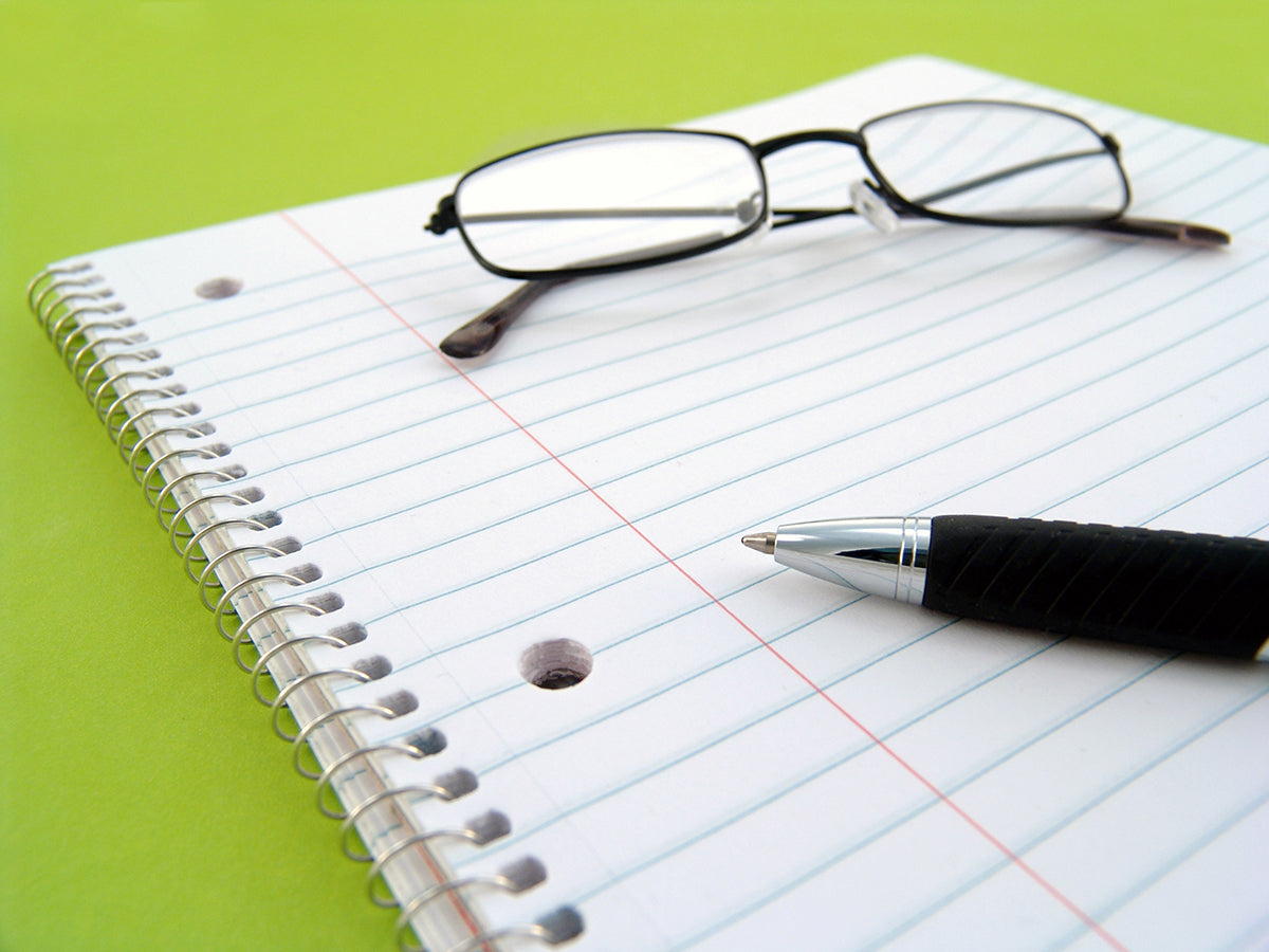 Free Pen and Glasses on Notebook Stock Photography