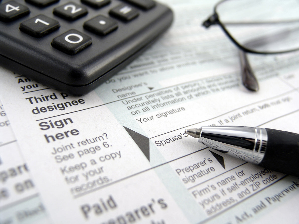 Free Pen and Calculator on Tax Forms Stock Photography