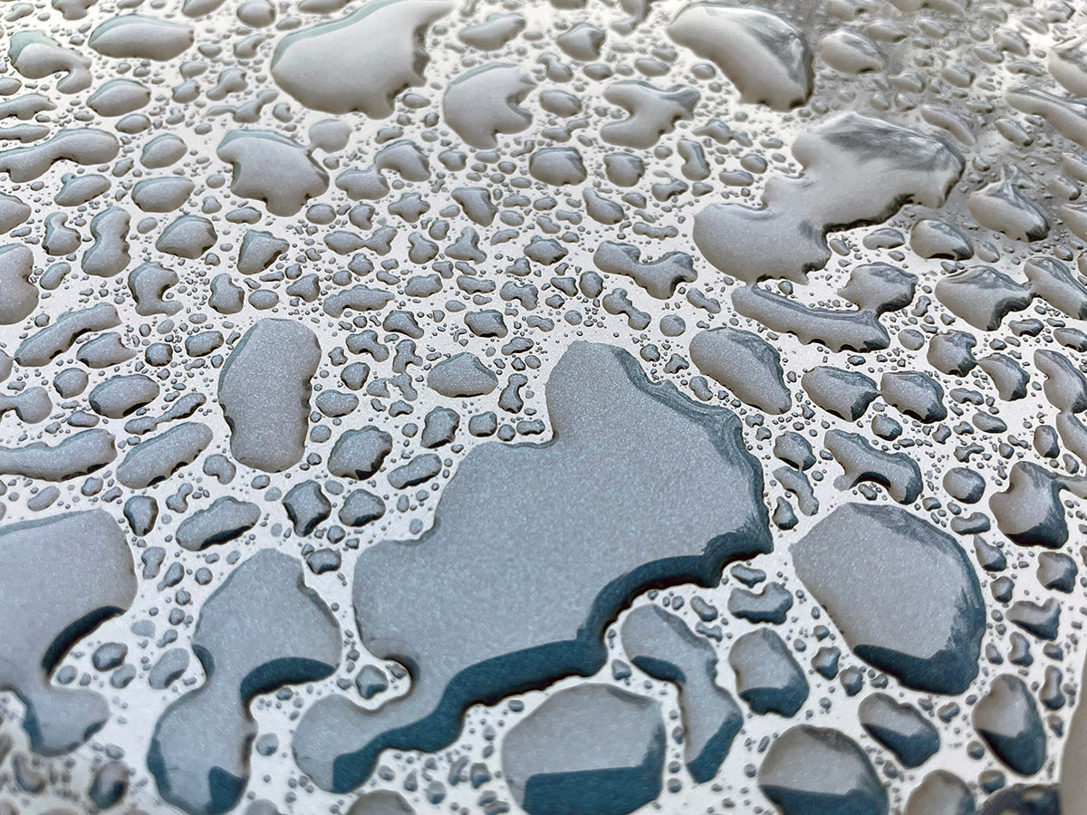 Free Water Droplets on Metallic Surface Stock Photography