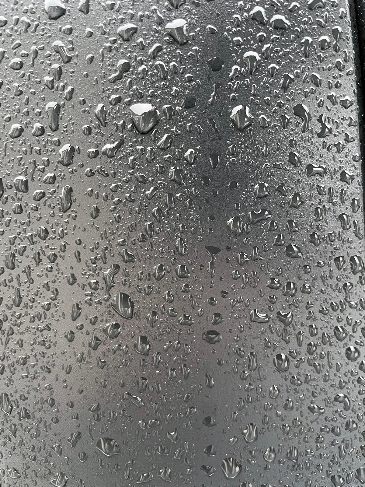 Free Raindrops on Metallic Surface Stock Photography