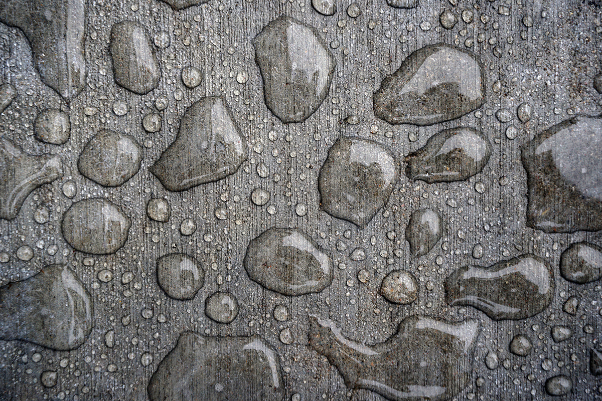Free Water Droplets on Rough Gray Surface Stock Photography