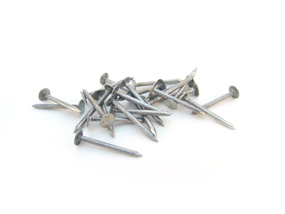 Free Scattered Steel Nails on White Background Stock Photography