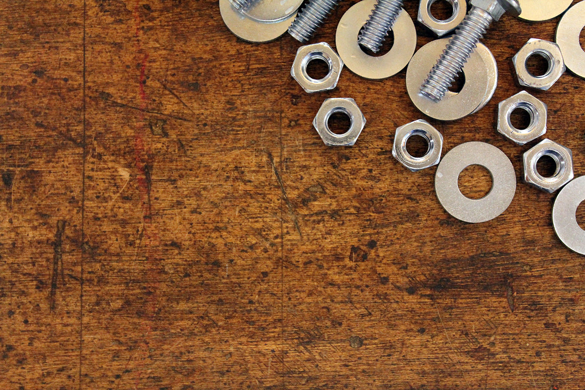 Free Nuts and Bolts on Wooden Surface Stock Photography