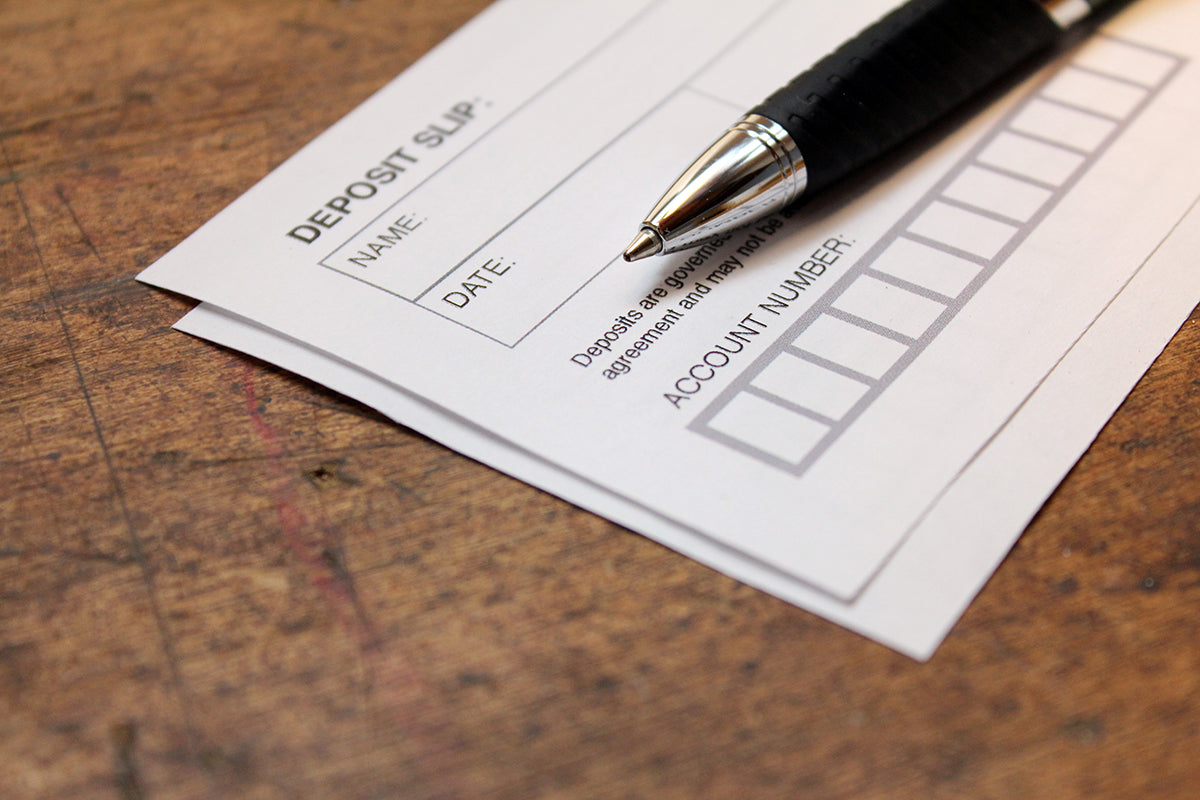 Free Deposit Slip and Pen on Table Stock Photography