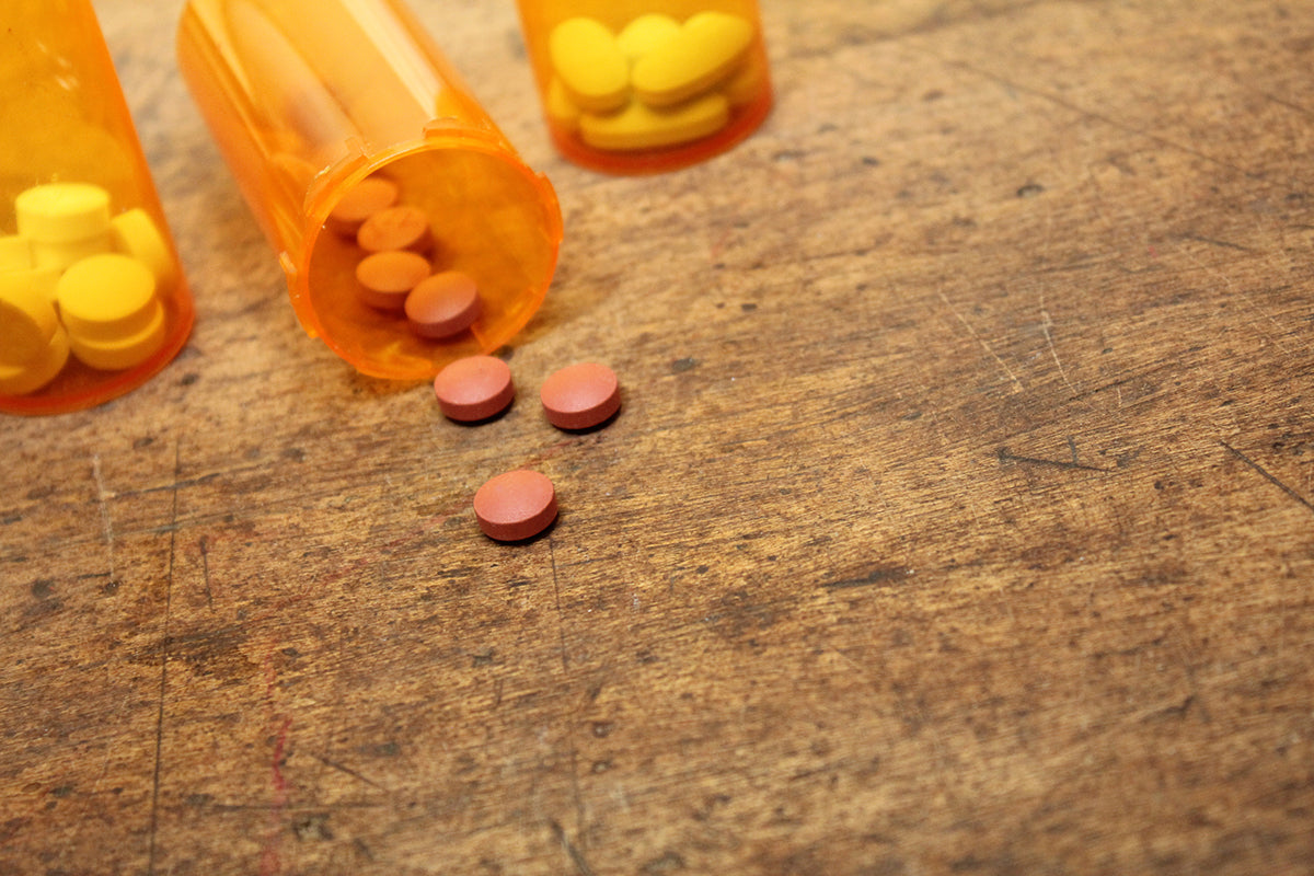 Free Red Pills Spilled from Prescription Bottles Stock Photography
