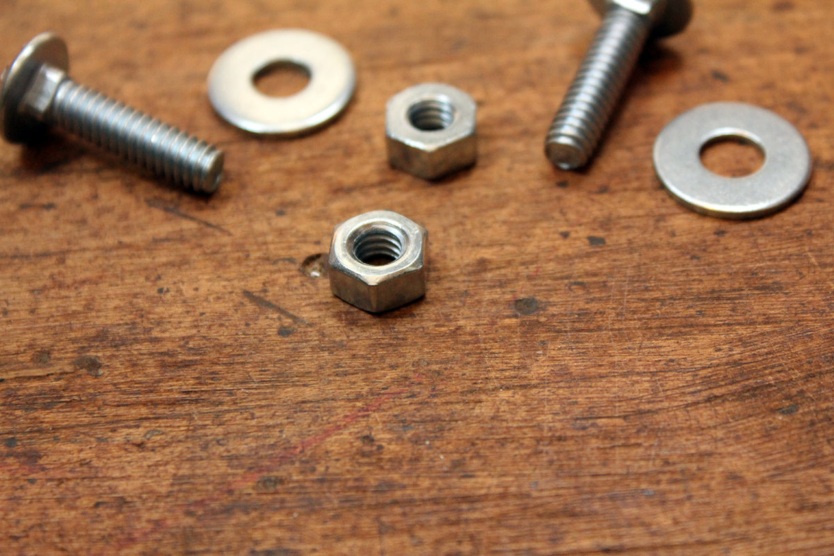 Free Assorted Nuts and Bolts on Wooden Surface Stock Photography