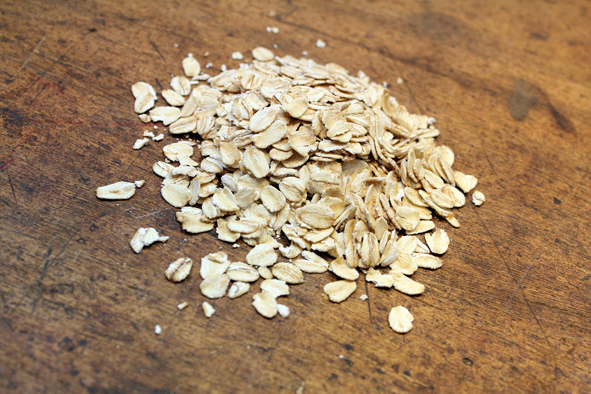 Free Pile of Rolled Oats on Wooden Table Stock Photography