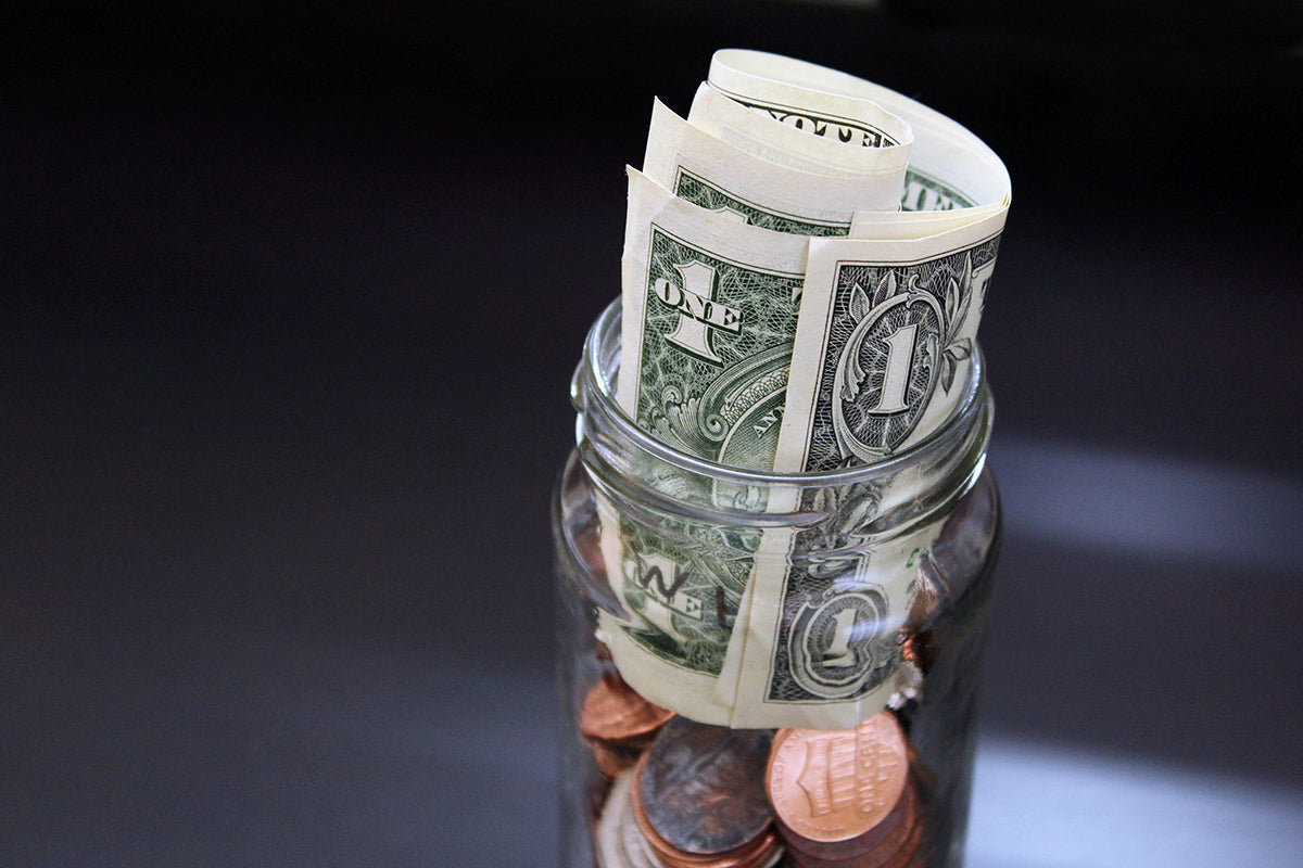 Free Money Jar with Bills and Coins Stock Photography
