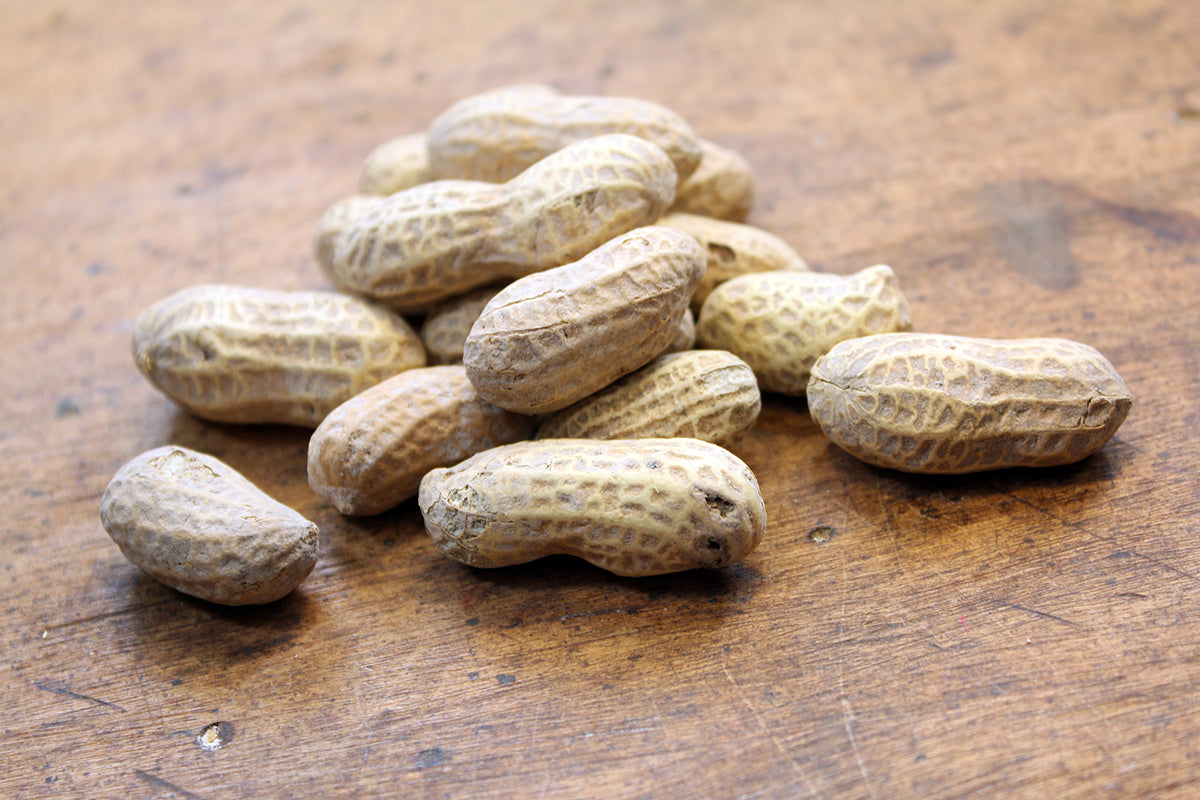 Free Unshelled Peanuts on Wood Stock Photography