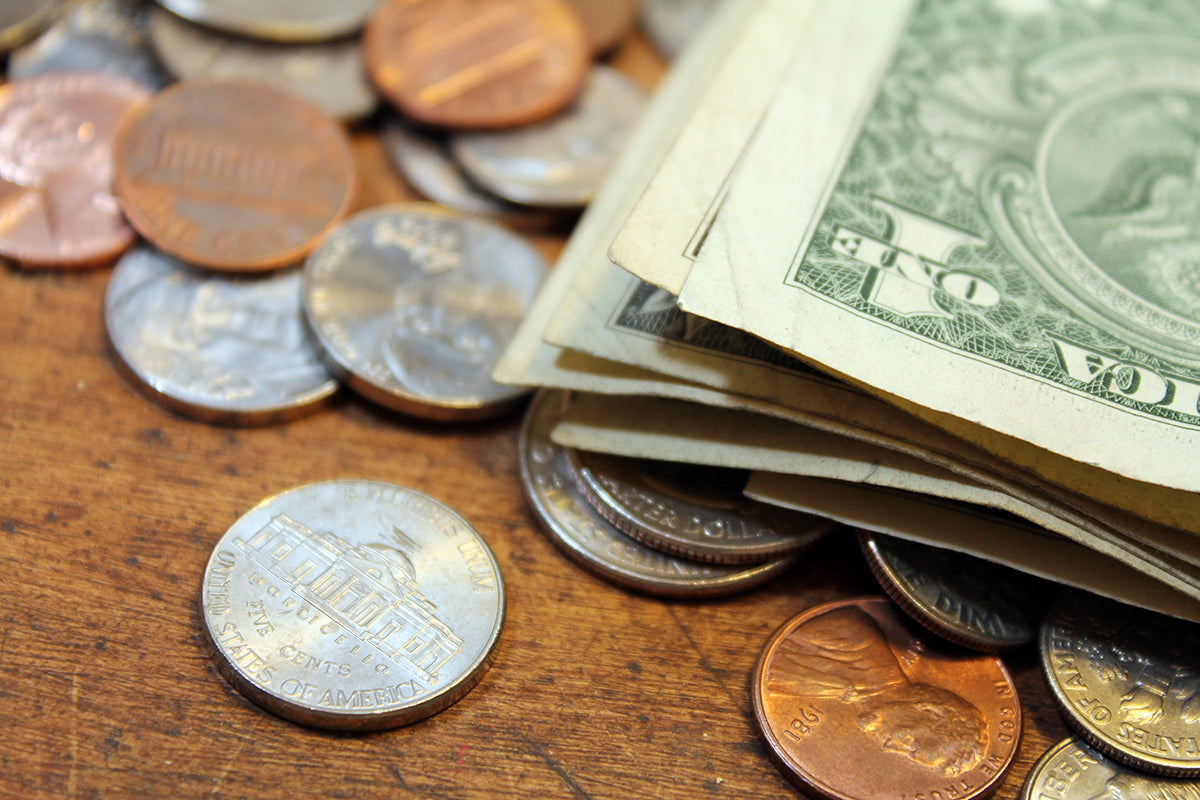 Free Pile of US Coins and Dollar Bills Stock Photography