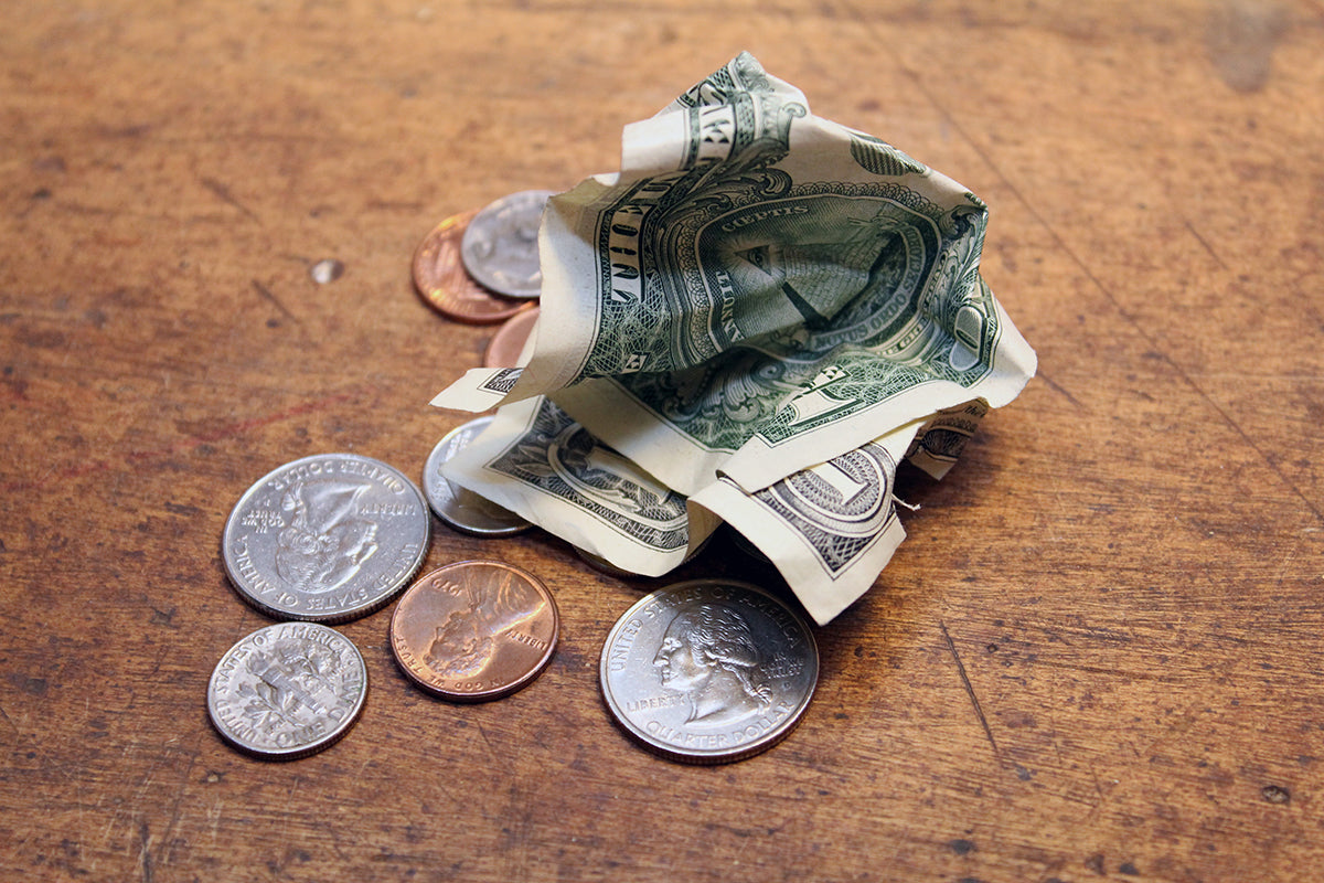 Free Loose Change and Crumpled Dollar Bills Stock Photography