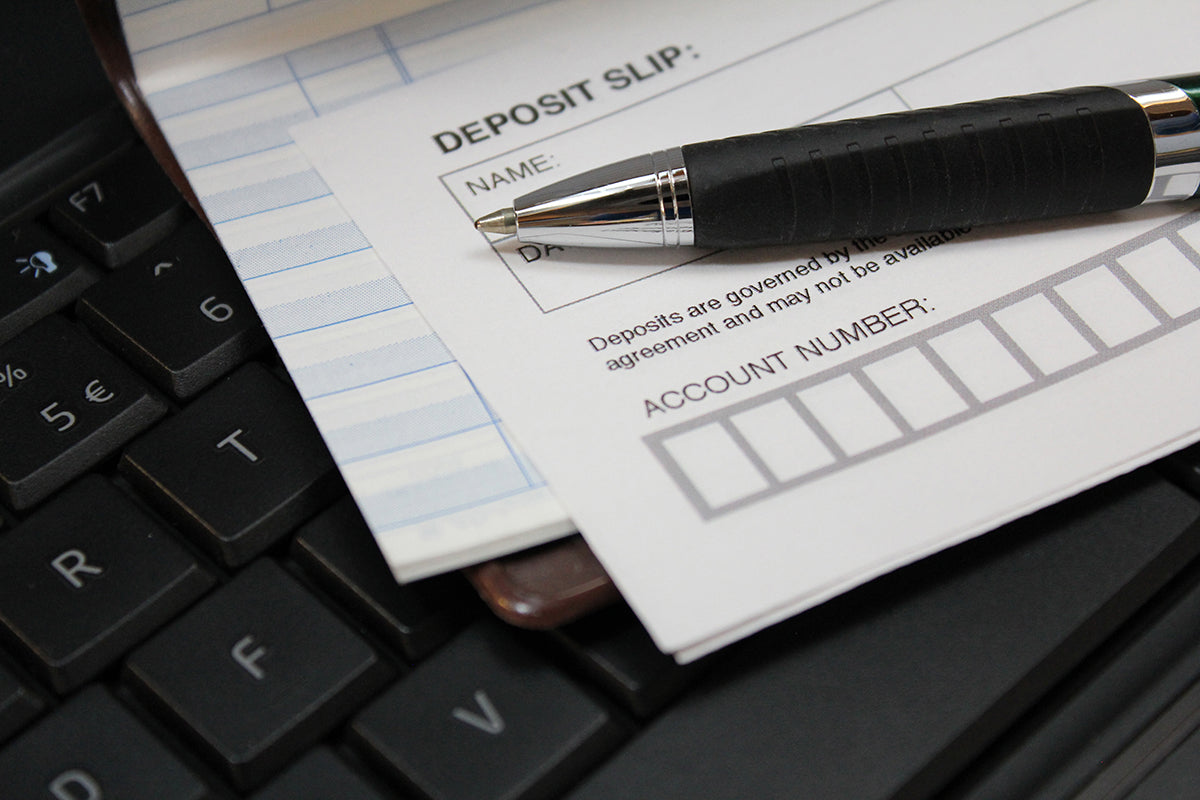 Free Deposit Slip and Pen on Keyboard Stock Photography