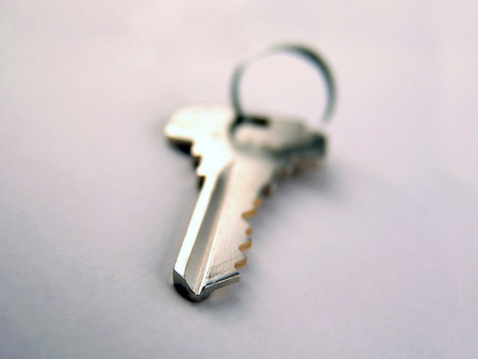 Free Key with Ring on White Surface Stock Photography