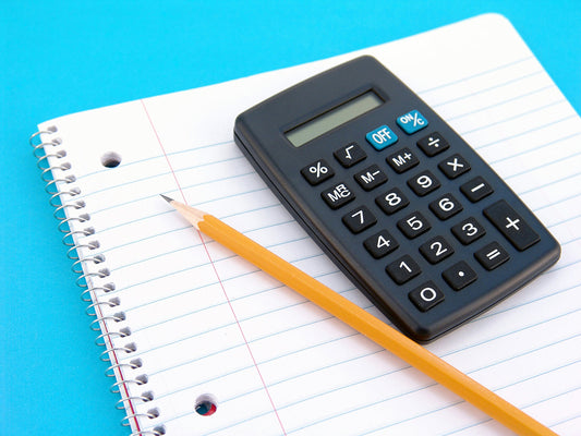 Free Calculator and Pencil on Notebook Stock Photography
