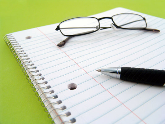 Free Pen and Glasses on Notebook Stock Photography