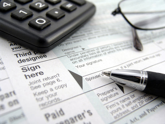 Free Pen and Calculator on Tax Forms Stock Photography