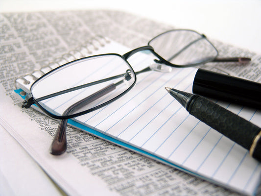 Free Reading Glasses on Notebook Stock Photography
