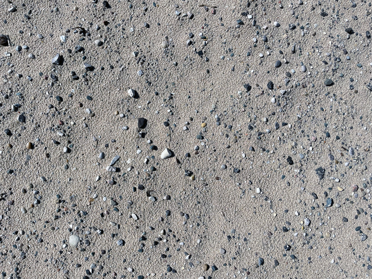 Free Pebbles on Beach Sand Stock Photography
