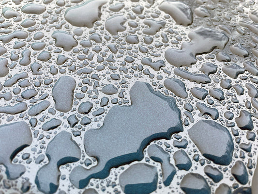 Free Water Droplets on Metallic Surface Stock Photography