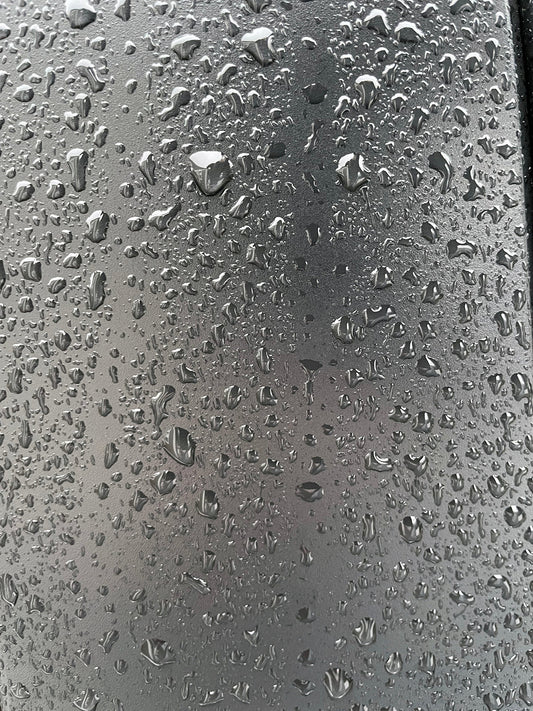 Free Raindrops on Metallic Surface Stock Photography