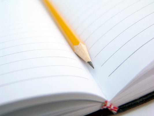 Free Yellow Pencil on Notebook Stock Photography
