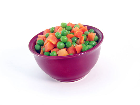 Free Diced Carrots and Peas in Red Bowl - Side Angle Stock Photography