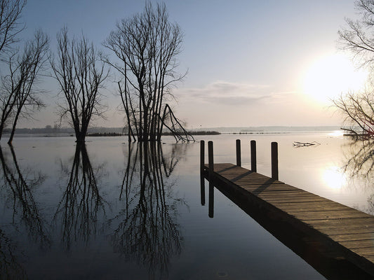 Free Sunrise Over Calm Lake with Dock Stock Photography