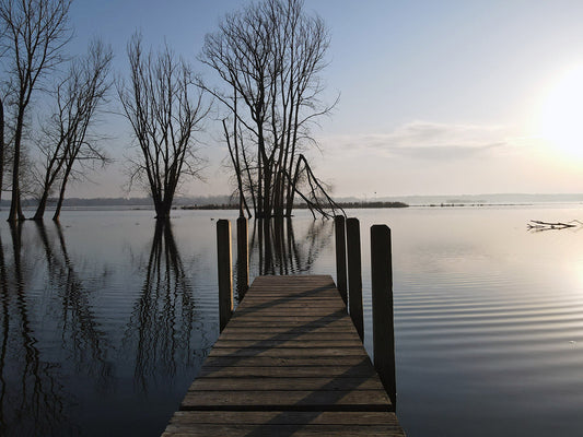 Free Dock Over Water at Sunrise Stock Photography