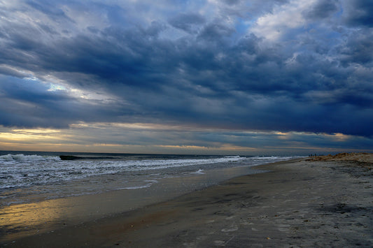 Free Storm Clouds and Rolling Surf on the Coast Stock Photography