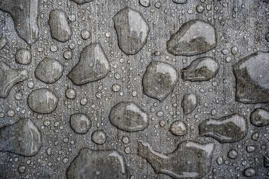 Free Water Droplets on Rough Gray Surface Stock Photography