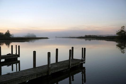 Free Foggy Sunrise over a Quiet River Dock Stock Photography