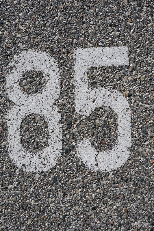 Free Number 85 on Cracked Pavement Stock Photography