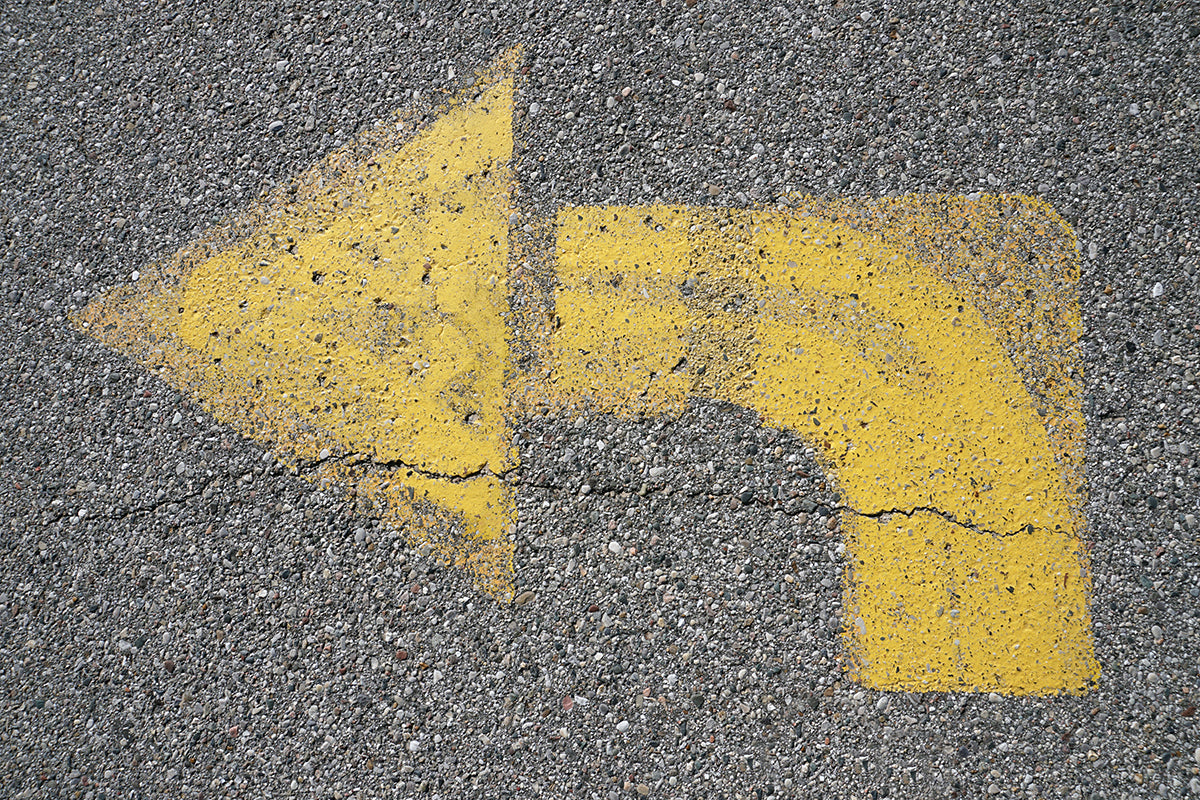 Free Curved Yellow Arrow on Pavement Stock Photography