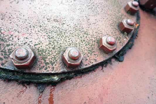 Free Rusty Bolts on Industrial Surface Stock Photography