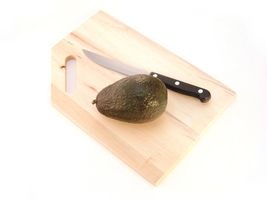 Free Whole Avocado on Cutting Board Stock Photography