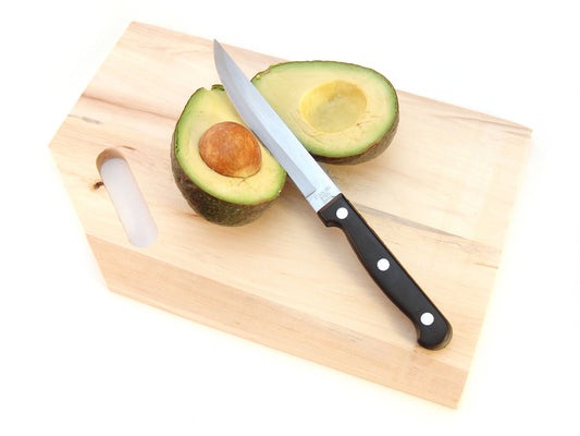Free Knife Across Halved Avocado Stock Photography