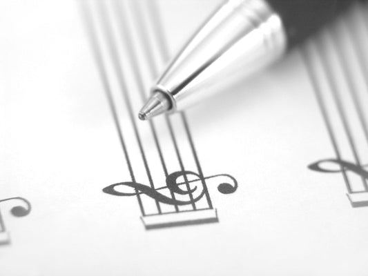 Free Pen Tip Touching Treble Clef on Sheet Music Stock Photography