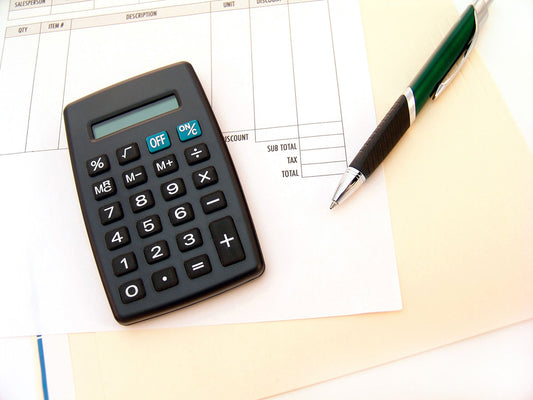 Free Calculator and Pen on Invoice Stock Photography