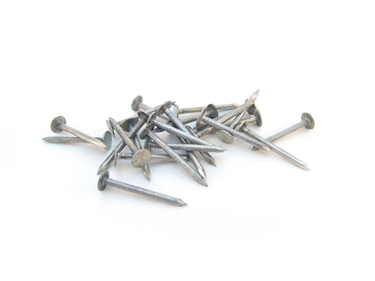 Free Scattered Steel Nails on White Background Stock Photography