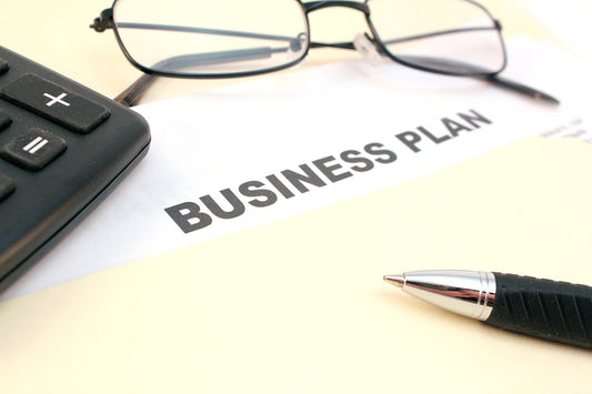 Free Business Plan Document with Pen and Glasses Stock Photography