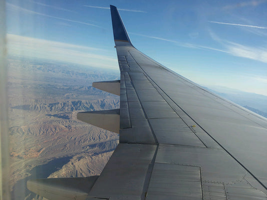 Free Airplane Over Desert Landscape Stock Photography