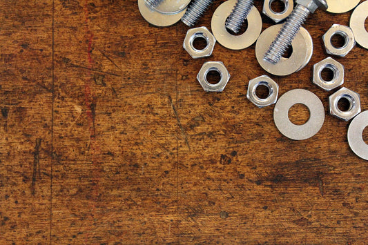Free Nuts and Bolts on Wooden Surface Stock Photography