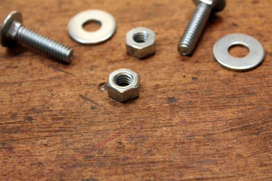 Free Assorted Nuts and Bolts on Wooden Surface Stock Photography