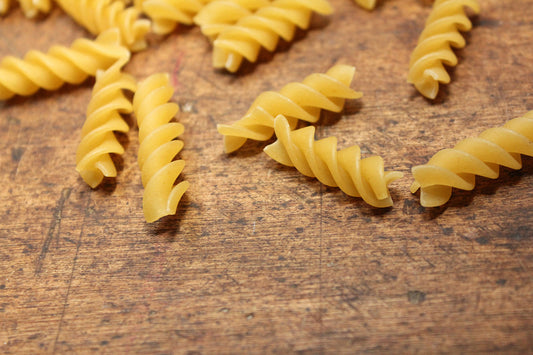 Free Rotini Pasta on Wooden Surface Stock Photography