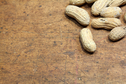 Free Peanuts on Rustic Wood Stock Photography