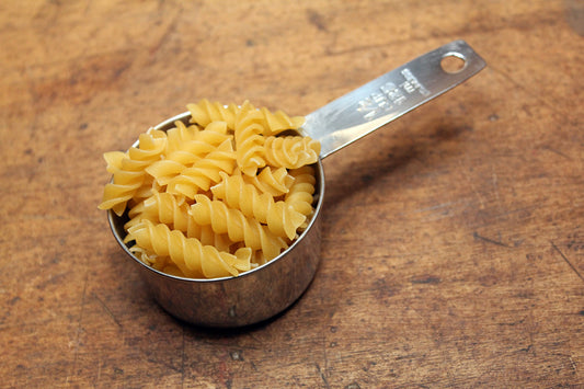 Free Dry Rotini Pasta in Measuring Cup Stock Photography
