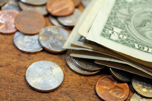 Free Pile of US Coins and Dollar Bills Stock Photography